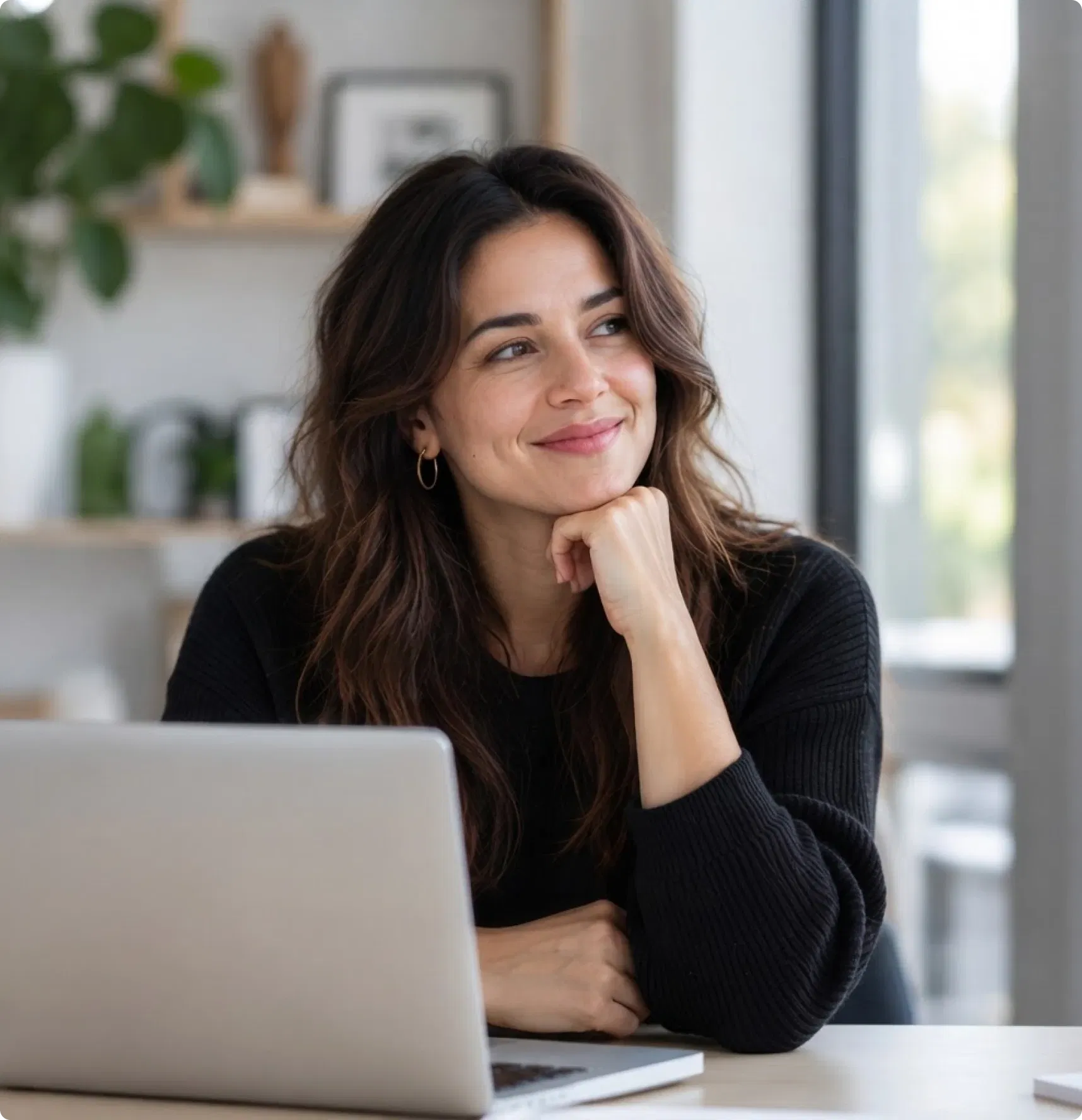 Creator smiling at her laptop