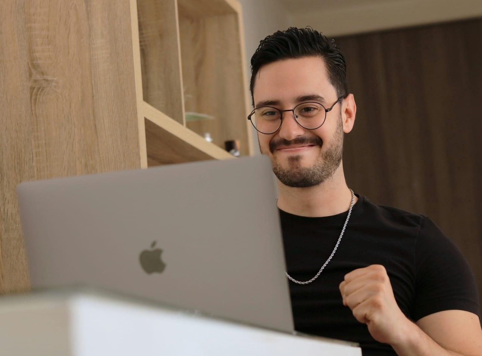 Business owner smiling at a new customer notification on a phone